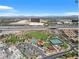 An aerial shot displays a neighborhood park, commercial buildings, and the city in the distance at 11420 Ogden Mills Dr # 101, Las Vegas, NV 89135