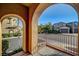 View from balcony showing neighboring homes, mature trees and the neighborhood street at 11420 Ogden Mills Dr # 101, Las Vegas, NV 89135