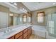 Bathroom boasts a double vanity, soaking tub, and enclosed glass shower at 11420 Ogden Mills Dr # 101, Las Vegas, NV 89135