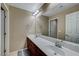 Bathroom with double sinks, a large mirror, and a warm neutral color scheme at 11420 Ogden Mills Dr # 101, Las Vegas, NV 89135