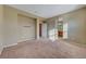 Spacious bedroom has neutral walls, neutral carpet and view into an ensuite bathroom at 11420 Ogden Mills Dr # 101, Las Vegas, NV 89135