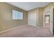 Comfortable bedroom with a closet, neutral paint, and an entryway to another room at 11420 Ogden Mills Dr # 101, Las Vegas, NV 89135