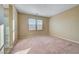 Bright bedroom with natural light showcases neutral walls, neutral carpeting, and a window at 11420 Ogden Mills Dr # 101, Las Vegas, NV 89135