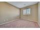 Cozy bedroom showcasing neutral walls, neutral carpeting, and a window at 11420 Ogden Mills Dr # 101, Las Vegas, NV 89135