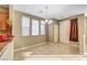 Dining area featuring tile flooring, light beige walls, and natural light from multiple windows at 11420 Ogden Mills Dr # 101, Las Vegas, NV 89135