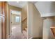 Hallway features tan walls, neutral carpeting, and leads to another room with a window at 11420 Ogden Mills Dr # 101, Las Vegas, NV 89135