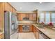 Bright kitchen with stainless steel refrigerator and granite countertops, perfect for cooking at 11420 Ogden Mills Dr # 101, Las Vegas, NV 89135