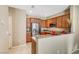Modern kitchen with stainless steel appliances, granite countertops, and natural wood cabinets at 11420 Ogden Mills Dr # 101, Las Vegas, NV 89135