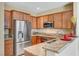Well-equipped kitchen with stainless steel appliances, granite countertops, and warm wood cabinets at 11420 Ogden Mills Dr # 101, Las Vegas, NV 89135