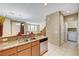 Kitchen with granite countertops, stainless steel dishwasher, and view of the stairs and washer/dryer at 11420 Ogden Mills Dr # 101, Las Vegas, NV 89135