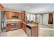 Modern kitchen featuring stainless steel appliances, granite countertops, and light wood cabinets at 11420 Ogden Mills Dr # 101, Las Vegas, NV 89135