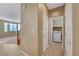 Hallway view leading to a laundry room with a white washer, showcasing the home's clean and functional design at 11420 Ogden Mills Dr # 101, Las Vegas, NV 89135