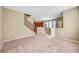 Open floor plan featuring tile flooring, neutral carpet, light beige walls, and a staircase at 11420 Ogden Mills Dr # 101, Las Vegas, NV 89135