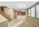 Open living room with a staircase, tile flooring, and views into the adjacent kitchen at 11420 Ogden Mills Dr # 101, Las Vegas, NV 89135