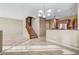 Open floor plan showcasing a seamless transition to the kitchen and stairs to second level at 11420 Ogden Mills Dr # 101, Las Vegas, NV 89135