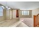 Open-concept space with tile and carpet flooring, a staircase, and views into other rooms at 11420 Ogden Mills Dr # 101, Las Vegas, NV 89135