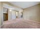 Spacious living room features neutral paint and carpeting, and an open floorplan at 11420 Ogden Mills Dr # 101, Las Vegas, NV 89135
