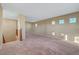 Spacious loft with carpet flooring, windows and wooden railing at 11420 Ogden Mills Dr # 101, Las Vegas, NV 89135