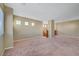 Spacious loft featuring carpet flooring, multiple windows, and a wooden railing at 11420 Ogden Mills Dr # 101, Las Vegas, NV 89135
