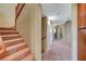 Staircase with neutral carpeting leads to the upper level of the home at 11420 Ogden Mills Dr # 101, Las Vegas, NV 89135