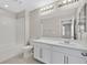 Bright bathroom featuring a shower-tub combo, toilet and a vanity with modern lighting at 117 Destiny Orchard Ct, Henderson, NV 89011