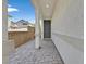 Inviting entryway features a paved walkway, covered porch with decorative columns, and a gray front door at 117 Destiny Orchard Ct, Henderson, NV 89011