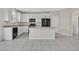 Bright kitchen featuring white cabinets, stainless steel appliances, granite countertops, and a center island at 117 Destiny Orchard Ct, Henderson, NV 89011