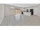 Spacious living room featuring tile flooring, with views of the open kitchen and sliding glass doors at 117 Destiny Orchard Ct, Henderson, NV 89011