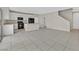 Open-concept living area showcasing tile flooring, a combined kitchen, and staircase access at 117 Destiny Orchard Ct, Henderson, NV 89011