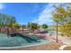 Community playground with mature trees and soft surface at 117 Destiny Orchard Ct, Henderson, NV 89011