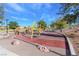 Community playground with swings, climbing rocks and -safe ground covering at 117 Destiny Orchard Ct, Henderson, NV 89011