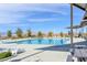 Community swimming pool with lounge chairs and shaded picnic area with seating at 117 Destiny Orchard Ct, Henderson, NV 89011