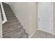 Carpeted staircase leading to the upper level next to an entry door at 117 Destiny Orchard Ct, Henderson, NV 89011