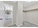 A well-organized walk-in closet with open doorway to updated bath and rod for hanging storage at 117 Destiny Orchard Ct, Henderson, NV 89011