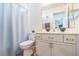 Bathroom featuring a toilet and vanity with a mirror and shower with a curtain at 1220 Basin Brook Dr, North Las Vegas, NV 89032