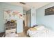 Cozy bedroom with a colorful world map and carpeted floors at 1220 Basin Brook Dr, North Las Vegas, NV 89032