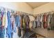 Spacious walk-in closet with hanging racks and shelving, perfect for storage at 1220 Basin Brook Dr, North Las Vegas, NV 89032