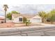 Charming single-story home with a red tile roof, desert landscaping, and an attached two-car garage at 1220 Basin Brook Dr, North Las Vegas, NV 89032