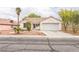 Charming single-story home features a well-maintained yard and attached two car garage at 1220 Basin Brook Dr, North Las Vegas, NV 89032