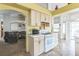 Functional kitchen with white appliances, ample cabinetry, tile countertops, and views into the living room at 1220 Basin Brook Dr, North Las Vegas, NV 89032