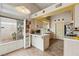 Functional kitchen with a breakfast bar, white cabinetry, modern appliances, and a large window with backyard views at 1220 Basin Brook Dr, North Las Vegas, NV 89032