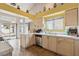 Bright kitchen featuring tile floors, stainless steel dishwasher, and window overlooking the backyard at 1220 Basin Brook Dr, North Las Vegas, NV 89032