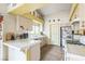 Well-lit kitchen featuring tile countertops, ample cabinet space, and modern appliances at 1220 Basin Brook Dr, North Las Vegas, NV 89032