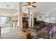 Inviting living room that opens to the kitchen, with a ceiling fan and comfortable furnishings at 1220 Basin Brook Dr, North Las Vegas, NV 89032