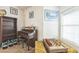 Cozy living area featuring a piano, chessboard, and natural light from a bright window with blinds at 1220 Basin Brook Dr, North Las Vegas, NV 89032