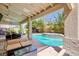Inviting backyard with a covered patio, outdoor seating, and a sparkling pool with a water feature at 1246 E Gary Ave, Las Vegas, NV 89123