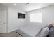 Cozy bedroom showcasing a modern bed, a wall-mounted TV, and a window for ample light at 1246 E Gary Ave, Las Vegas, NV 89123