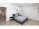 This bedroom has wood floors, artwork, and a comfortable bed with soft, neutral bedding at 1246 E Gary Ave, Las Vegas, NV 89123