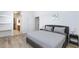 Bright bedroom with wood floors, walk in closet, and a comfortable bed with soft, neutral bedding at 1246 E Gary Ave, Las Vegas, NV 89123