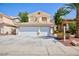 Two-story home featuring a three-car garage and low-maintenance landscaping in the front yard at 1246 E Gary Ave, Las Vegas, NV 89123